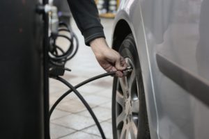 someone blowing up the tyre of a vehicle