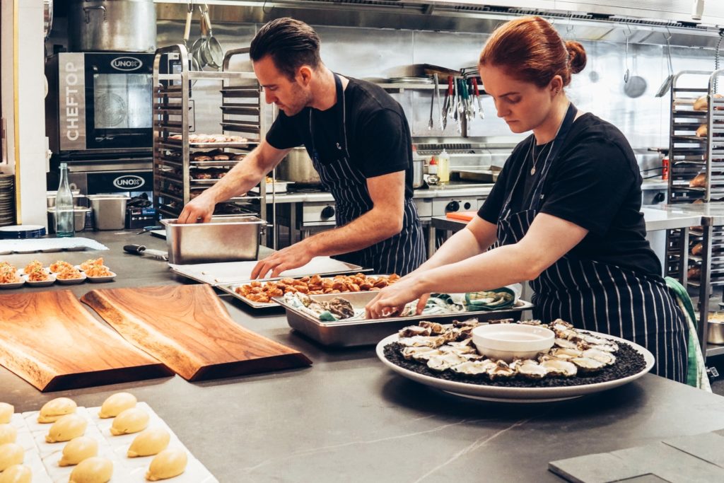 Two chefs working with a good distance between them