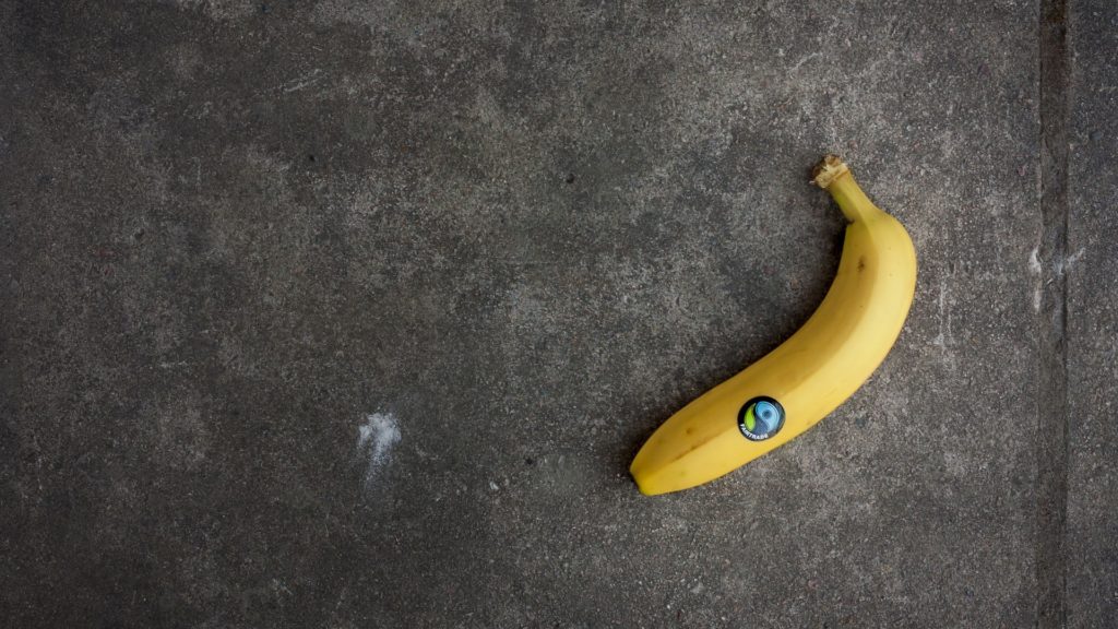 A banana with afair trade sticker on
