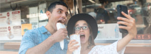 man and woman eating mobile street food